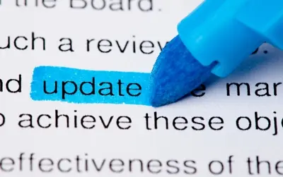A blue marker highlighting the word update in a printed document