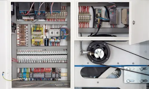 Open electrical control cabinets showing wiring looms and process control hardware
