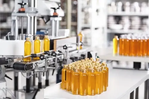 Amber bottles moving through a filling and packaging line